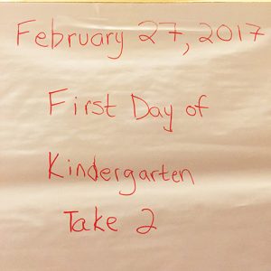 Flipboard paper reading "February 27, 2017" at the top and "First Day of Kindergarten Take 2" below